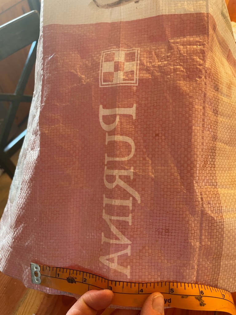 measuring the side creases of the feed sack 